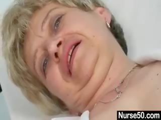 Busty Granny In Uniform Stretching Her Aged Pussy